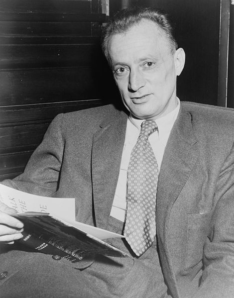 Picture of Nelson Algren. Nelson Algren, half-length portrait, seated, facing front, holding copy of his book 'A Walk on the Wild Side' / World Telegram photo by Walter Albertin.