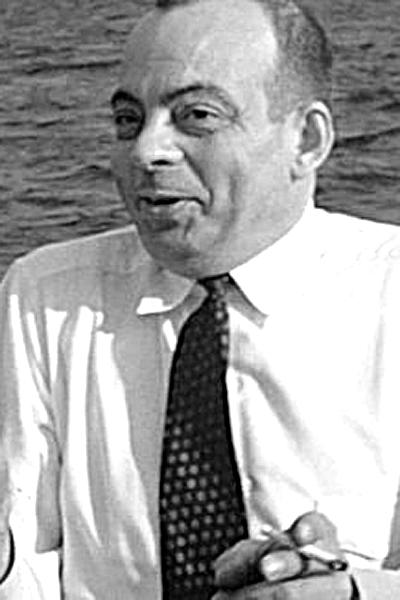 This Canadian work is in the public domain in Canada because its copyright has expired due to one of the following: (1) it is a photograph that was created prior to January 1, 1949, or (2) the creator died more than 50 years ago. Picture of Antoine de Saint-Exupéry. A still image of Saint-Exupéry during a boat tour of a lake near Montreal, Canada, filmed in May 1942. The image was extracted from a single frame of an approximate two minute length 16mm color Kodachrome movie shot casually while meeting with his Canadian publisher Bernard Valiquette and friends, along with wife Consuelo (all of whom are out of view in the image).